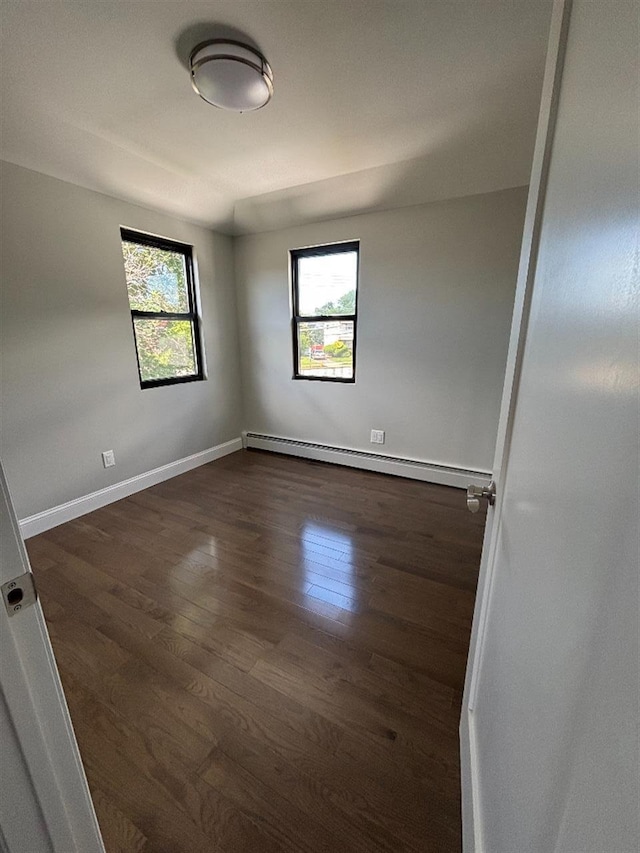 177-37 115th Ave, Saint Albans, NY 11434 - spare room featuring healthy amount of natural light, baseboard heating, dark wood finished floors, and baseboards