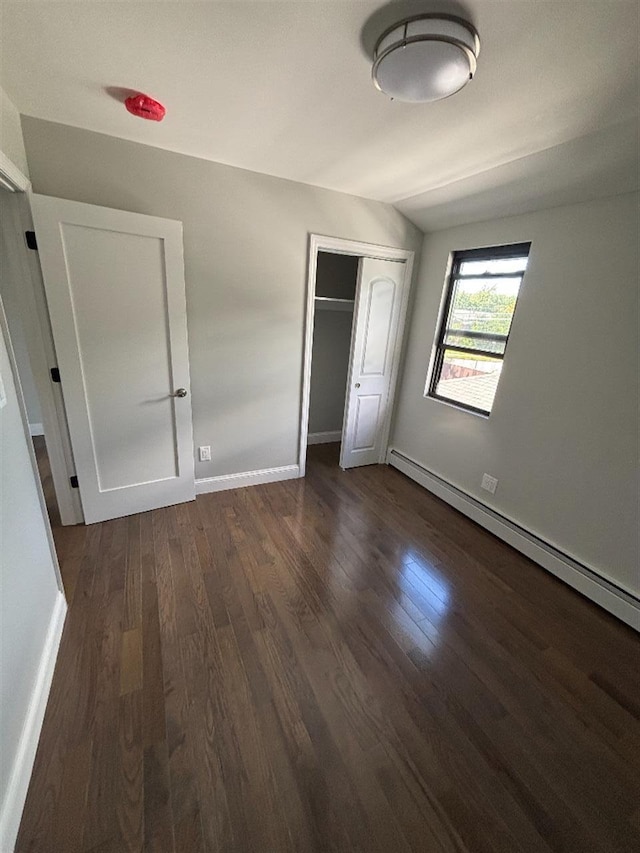 177-37 115th Ave, Saint Albans, NY 11434 - unfurnished bedroom with a baseboard radiator, dark wood finished floors, a closet, and baseboards