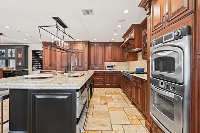 84 S Woods Rd, Woodbury, NY 11797 - kitchen with stainless steel appliances, stone tile flooring, a center island with sink, visible vents, and recessed lighting