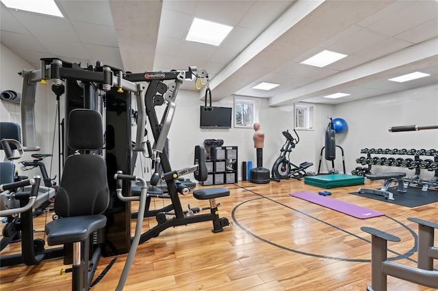 84 S Woods Rd, Woodbury, NY 11797 - workout area featuring a paneled ceiling and light wood finished floors