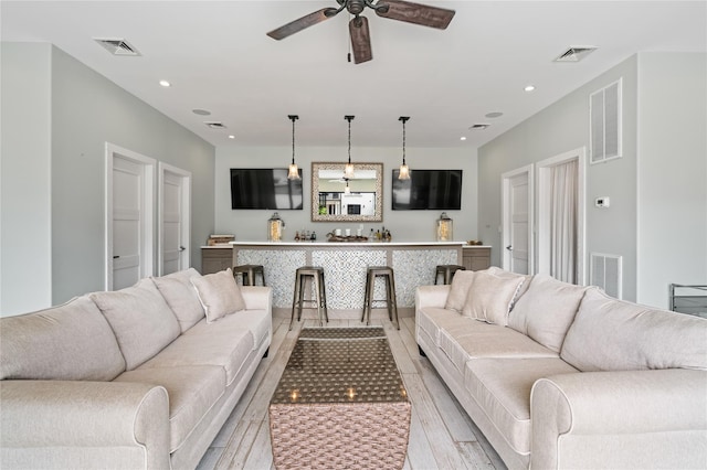 84 S Woods Rd, Woodbury, NY 11797 - living area with light wood-type flooring, indoor bar, and visible vents