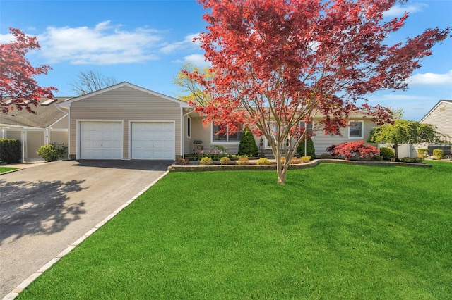 view of front of property with an attached garage, driveway, and a front yard