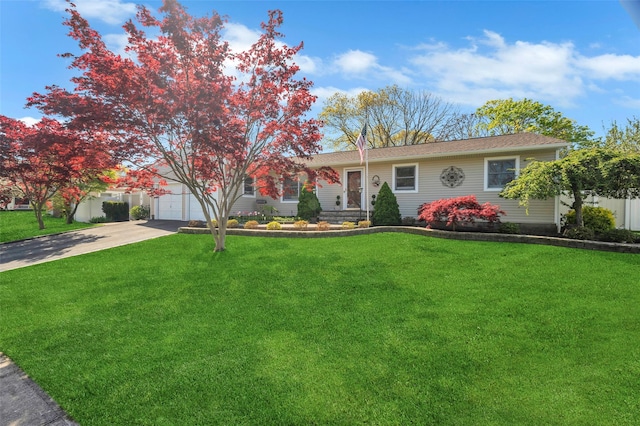 ranch-style home with concrete driveway, an attached garage, and a front yard