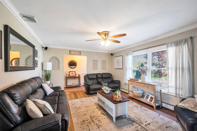 living area with ceiling fan, visible vents, crown molding, wood finished floors, and a baseboard heating unit