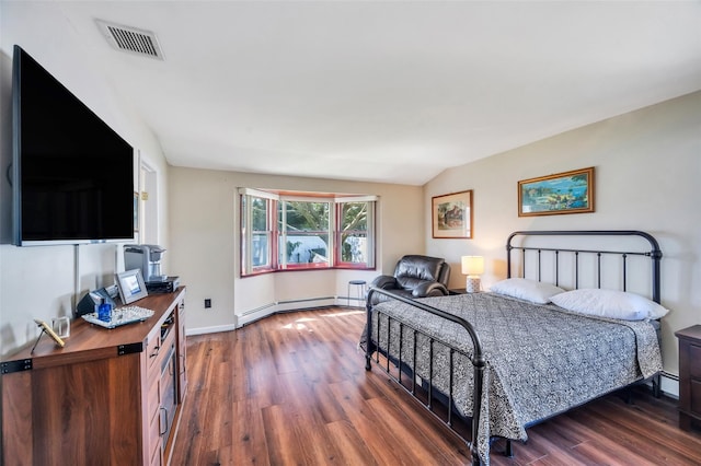 bedroom featuring baseboards, a baseboard heating unit, wood finished floors, and visible vents
