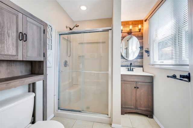full bathroom with tile patterned floors, a shower stall, and toilet