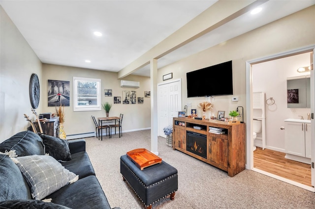 living area with carpet floors, recessed lighting, a baseboard heating unit, and a wall unit AC