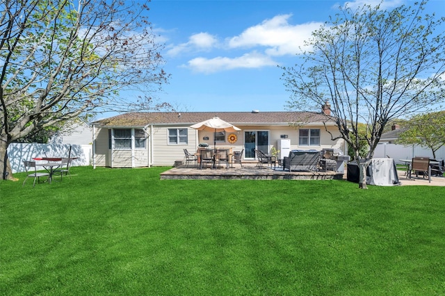rear view of house with outdoor dining area, a fenced backyard, a patio area, and a yard