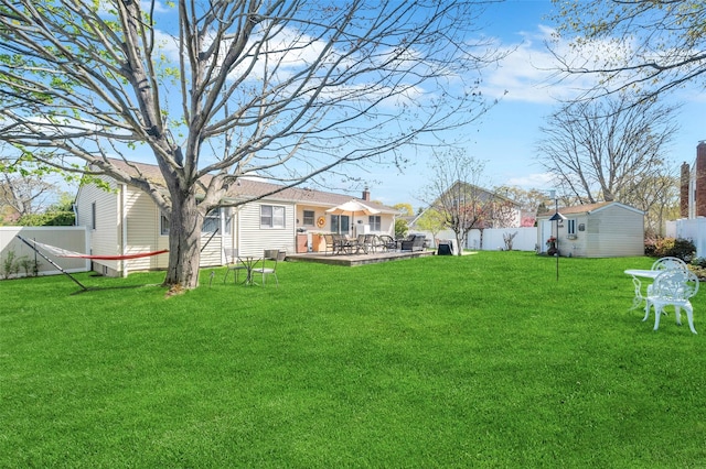 view of yard with a fenced backyard, an outdoor structure, and a patio area