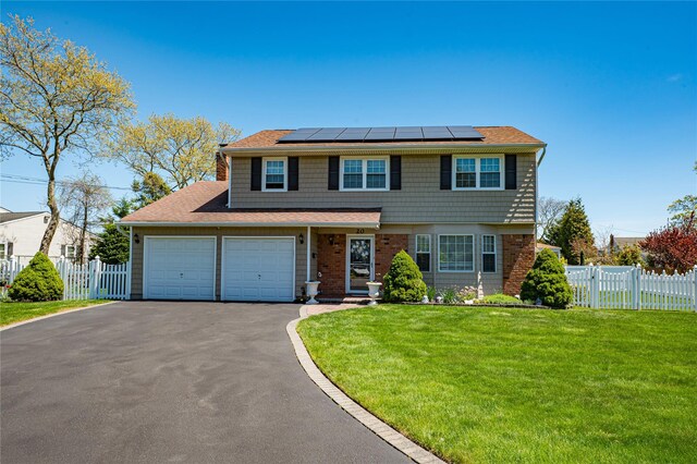 20 Bayview Rd, Amityville, NY 11701 - traditional-style home featuring roof mounted solar panels, driveway, fence, and a front yard