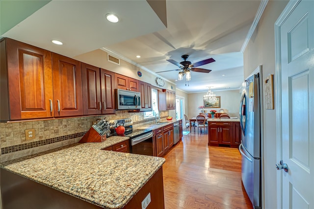 20 Bayview Rd, Amityville, NY 11701 - kitchen featuring a sink, a peninsula, ornamental molding, visible vents, and appliances with stainless steel finishes
