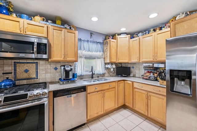 kitchen featuring appliances with stainless steel finishes, a sink, recessed lighting, light tile patterned floors, and backsplash