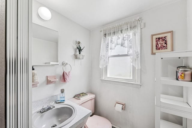 half bathroom featuring toilet and vanity