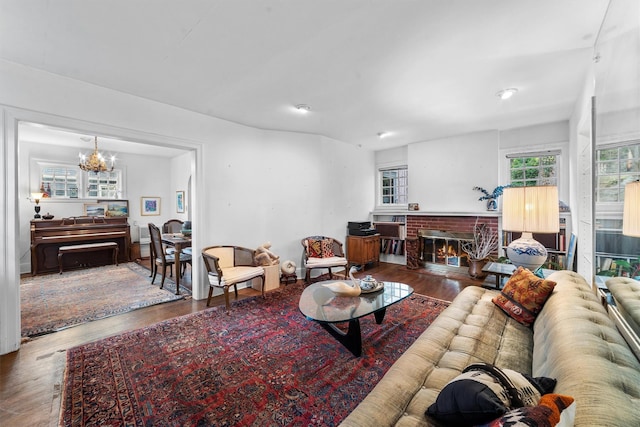 50 Oakland Ave, Tuckahoe, NY 10707 - living room featuring wood finished floors, a fireplace, and a notable chandelier
