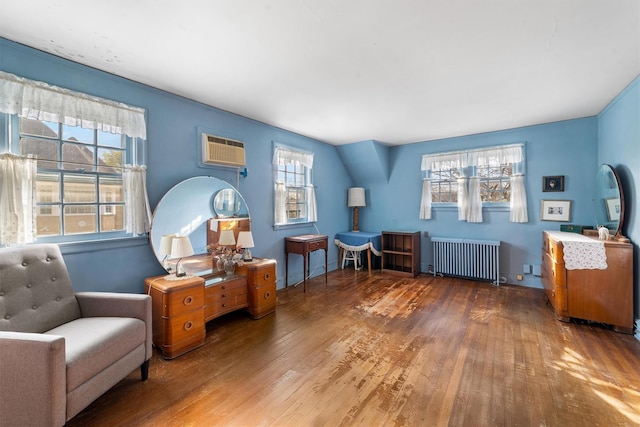 50 Oakland Ave, Tuckahoe, NY 10707 - living area featuring an AC wall unit, hardwood / wood-style floors, and radiator heating unit