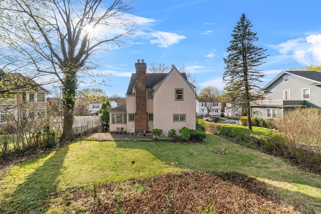 50 Oakland Ave, Tuckahoe, NY 10707 - view of home's exterior featuring fence, a patio area, a chimney, and a lawn