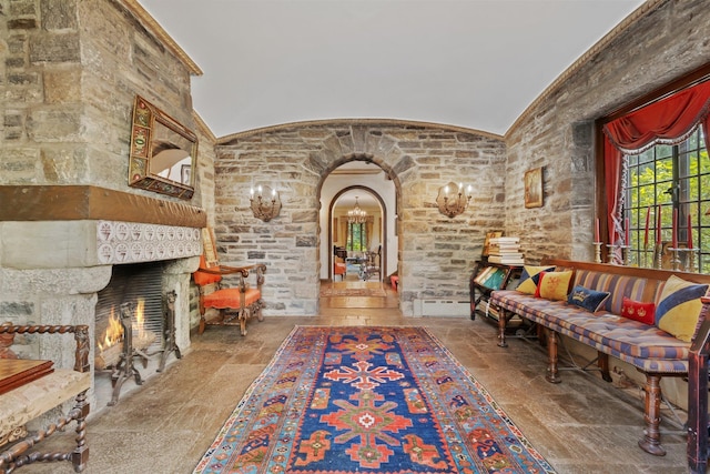 50 Hampshire Rd, Bronxville, NY 10708 - living area with a lit fireplace, lofted ceiling, arched walkways, and stone tile floors