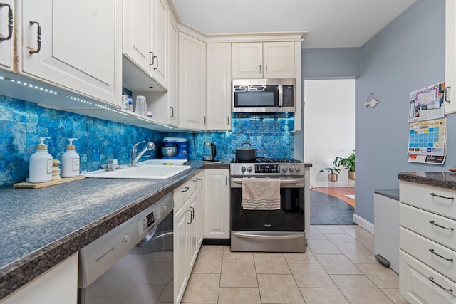 299 Whitman Dr, Brooklyn, NY 11234 - kitchen with a sink, backsplash, dark countertops, and stainless steel appliances