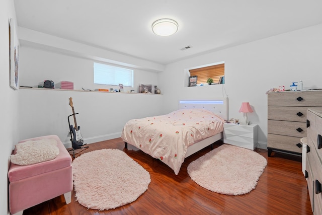 299 Whitman Dr, Brooklyn, NY 11234 - bedroom featuring baseboards, wood finished floors, and visible vents