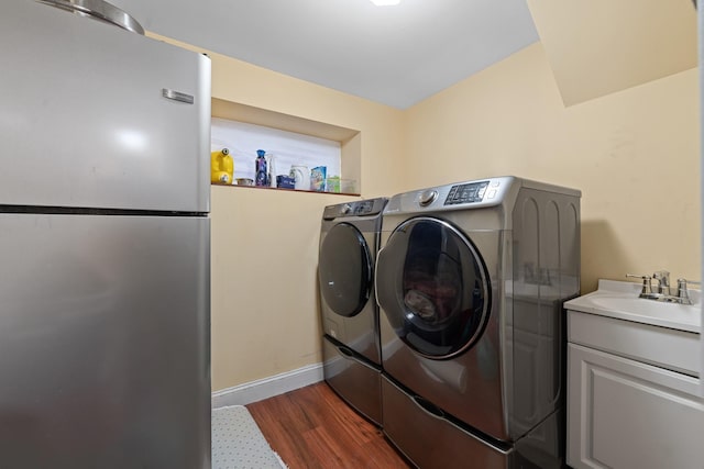 299 Whitman Dr, Brooklyn, NY 11234 - laundry room with a sink, baseboards, washing machine and dryer, and dark wood-style flooring