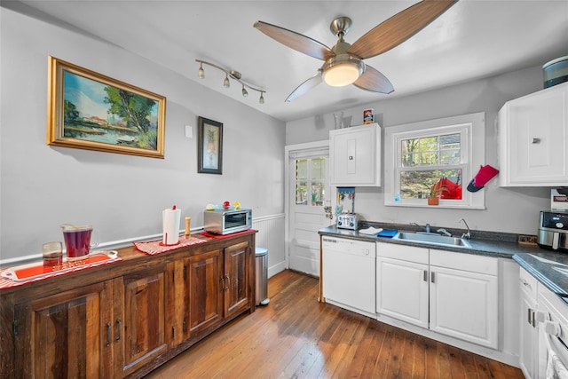 57 Higgins Trl, Monroe, NY 10950 - kitchen with hardwood / wood-style floors, dark countertops, white cabinetry, a sink, and dishwasher