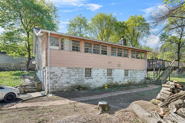 57 Higgins Trl, Monroe, NY 10950 - view of home's exterior featuring stairway, fence, a chimney, and a wooden deck
