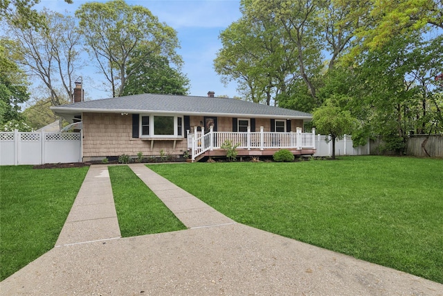 single story home featuring a chimney, a shingled roof, and a deck