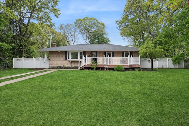 ranch-style home featuring a chimney, a deck, and a shingled roof