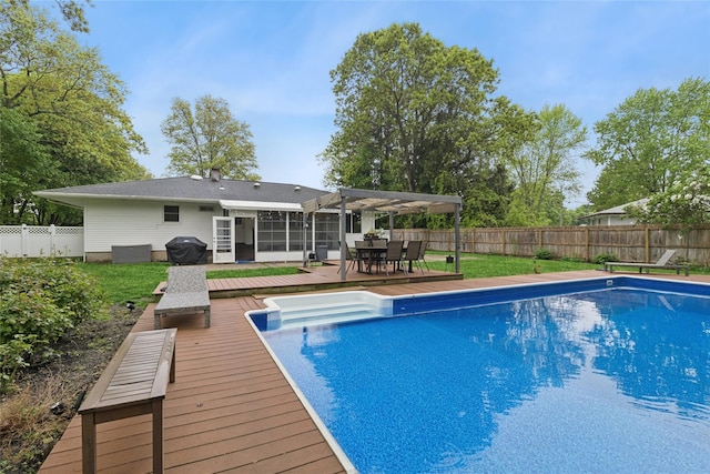 view of pool featuring a deck, a sunroom, outdoor dining area, and a pergola