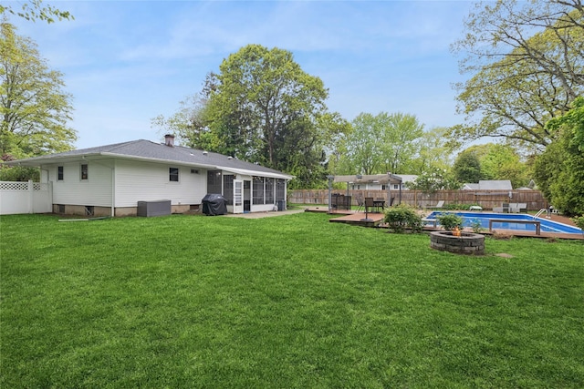 view of yard with a sunroom and a fire pit