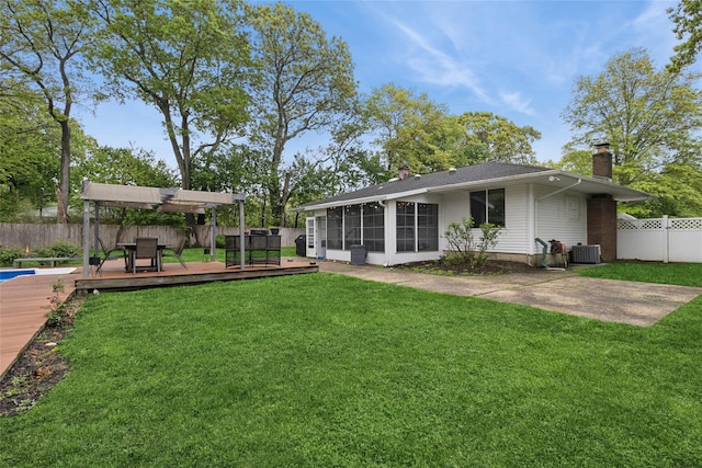 rear view of property with a chimney, a sunroom, a deck, cooling unit, and a pergola
