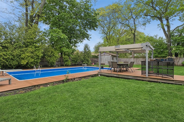 view of pool featuring a deck, a pergola, outdoor dining space, and a storage unit