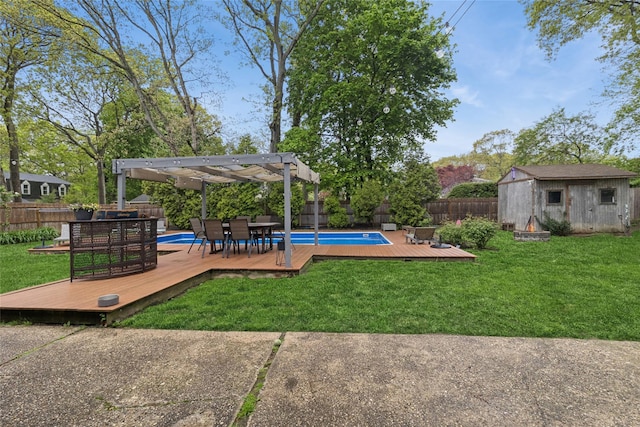 view of yard featuring a wooden deck, a pergola, a storage unit, an outbuilding, and outdoor dining area