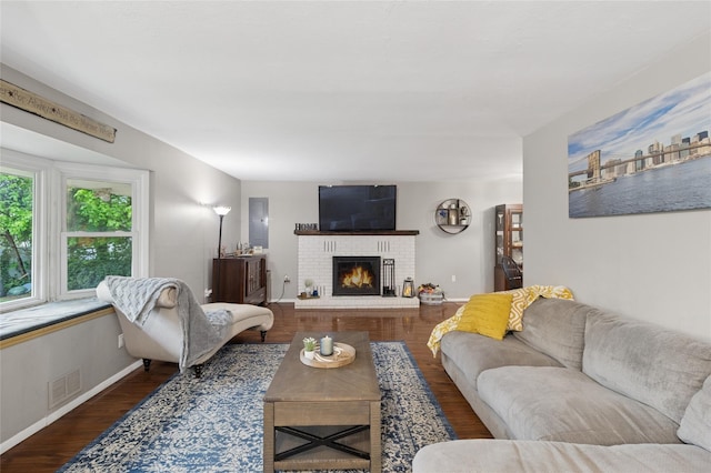 living room with a fireplace, wood finished floors, and baseboards