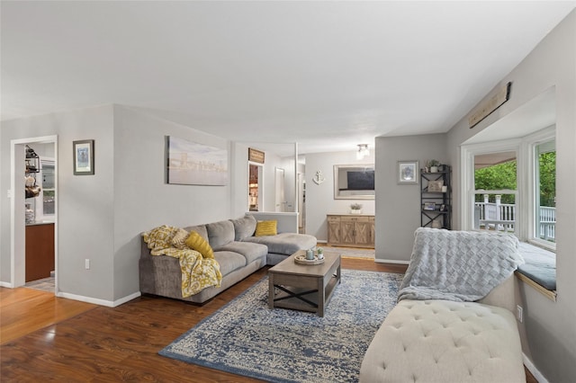 living area featuring wood finished floors and baseboards