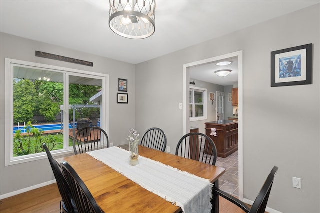 dining area with baseboards and a chandelier
