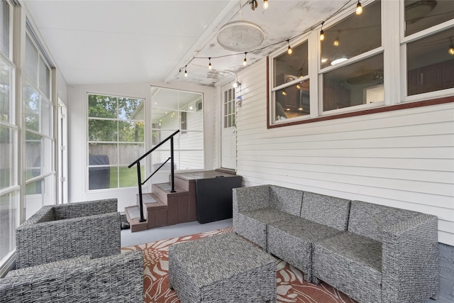 sunroom with track lighting, an outdoor hangout area, and lofted ceiling