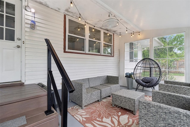 sunroom / solarium featuring an outdoor living space and track lighting