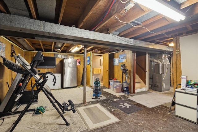 exercise room with heating unit and wood walls