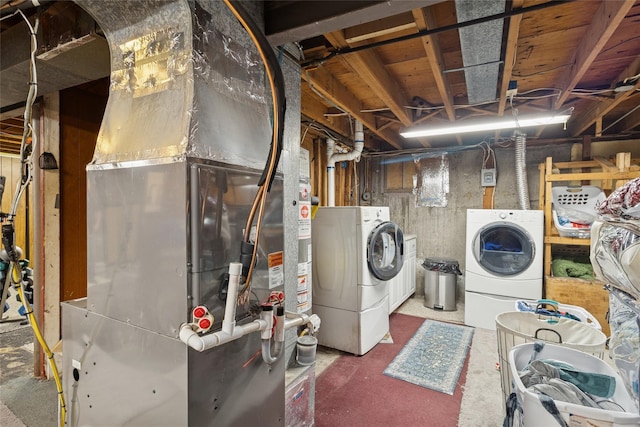laundry room featuring washer and dryer and heating unit