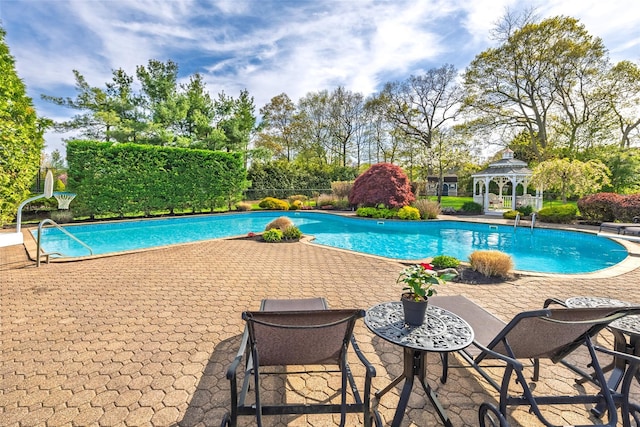view of swimming pool featuring a gazebo, a patio area, and a fenced in pool