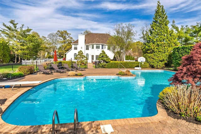 view of pool with a fenced in pool, a patio area, and fence