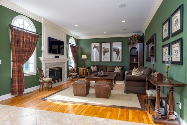 living area featuring crown molding, a brick fireplace, recessed lighting, wood finished floors, and visible vents