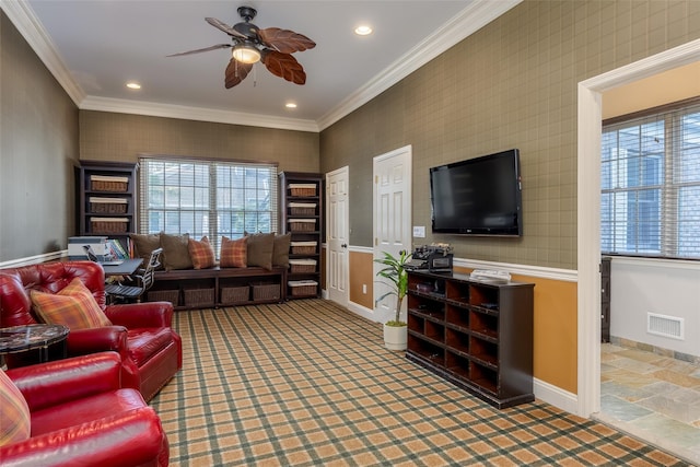 living area featuring crown molding, ceiling fan, visible vents, and baseboards
