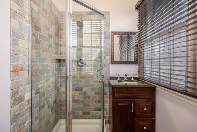 full bath with vanity and a shower stall