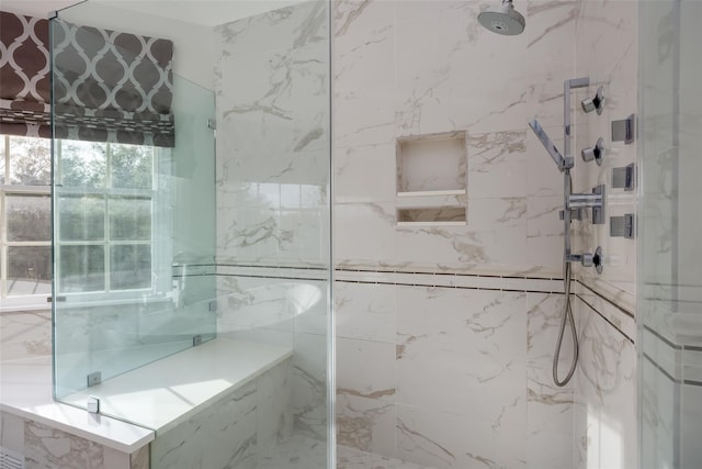 full bath featuring a marble finish shower