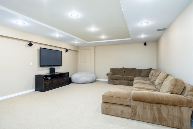 carpeted living room with recessed lighting, baseboards, visible vents, and a tray ceiling