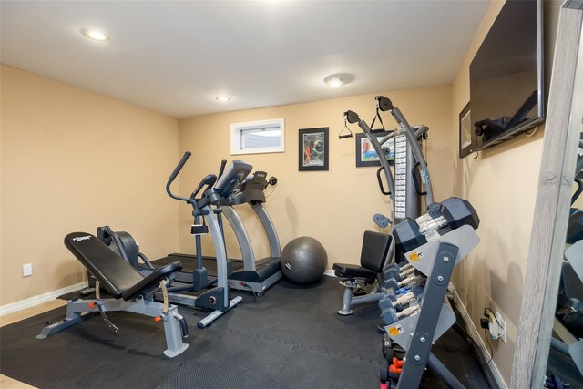 exercise area featuring baseboards and recessed lighting