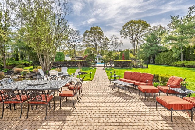 view of patio with outdoor lounge area, fence, and outdoor dining space