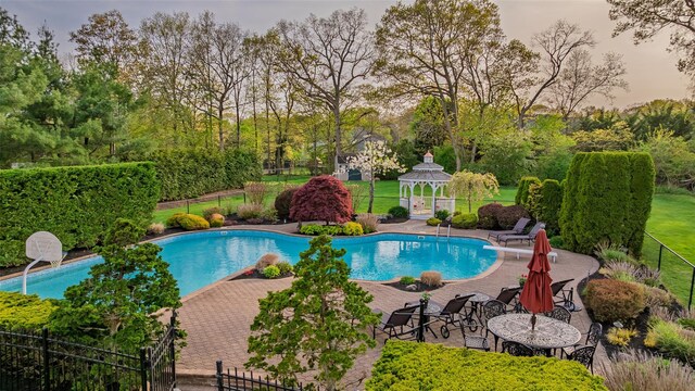 view of swimming pool with fence, a gazebo, a fenced in pool, and a patio area